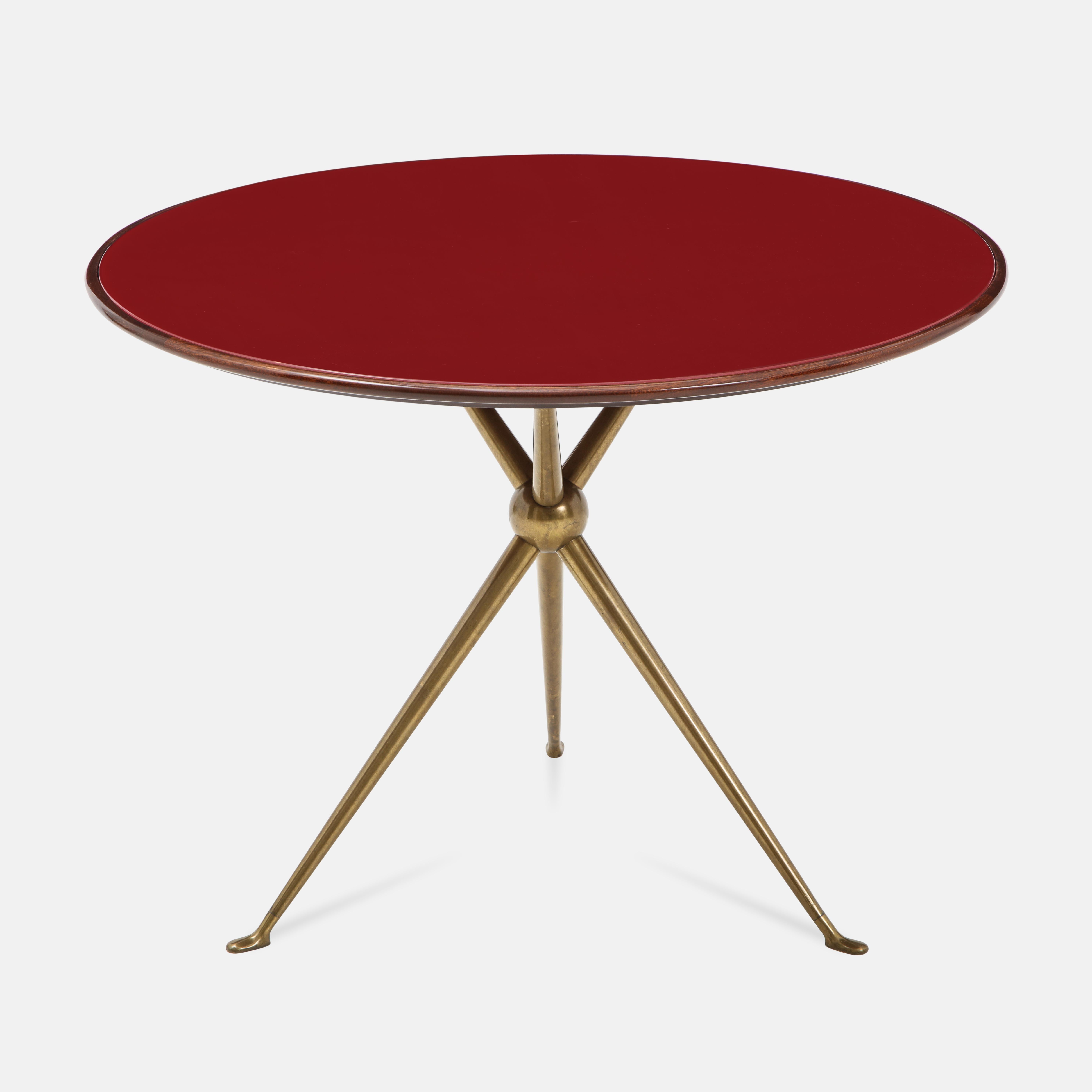 Rare occasional or side table with wood top and inset reverse painted deep red glass atop gilt brass tripod base, designed by Osvaldo Borsani and manufactured by Arredamenti Borsani Varedo, Milan. Beautifully modern lines and proportions in a