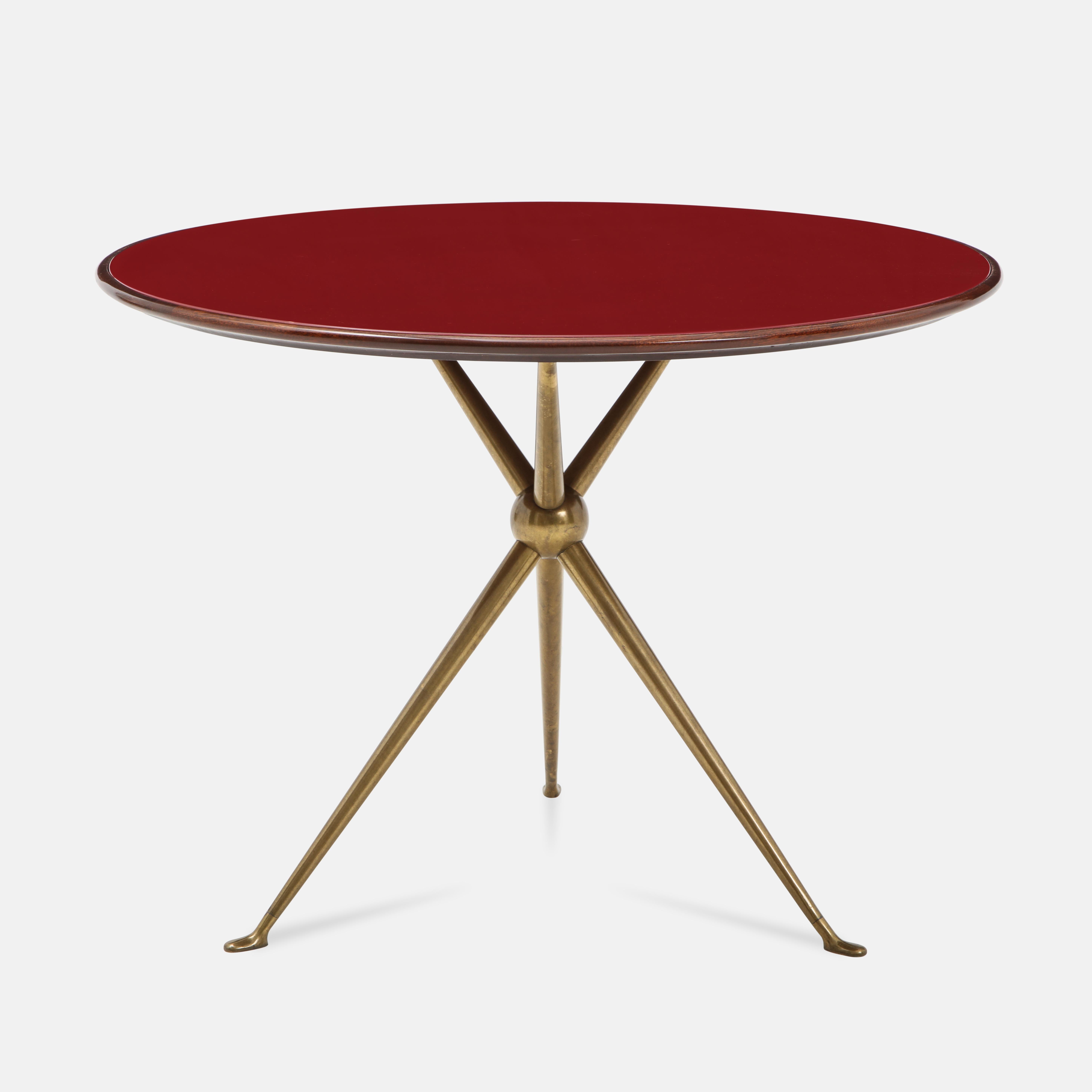 Designed by Osvaldo Borsani and manufactured by Arredamenti Borsani Varedo, Milan in 1940s, rare matched pair of round side tables with wood top and inset reverse painted deep red glass atop gilt brass tripod base. Beautifully modern lines and