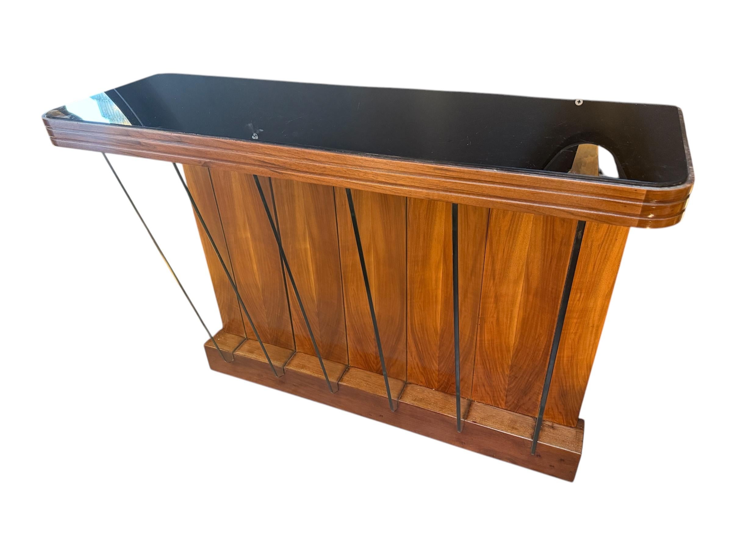 Restored Italian console or entryway table by Osvaldo Borsani, dating to the early 1950s—a period known for its clean lines, elegant proportions, and sophisticated material combinations. The piece is made from richly grained walnut wood, paired with