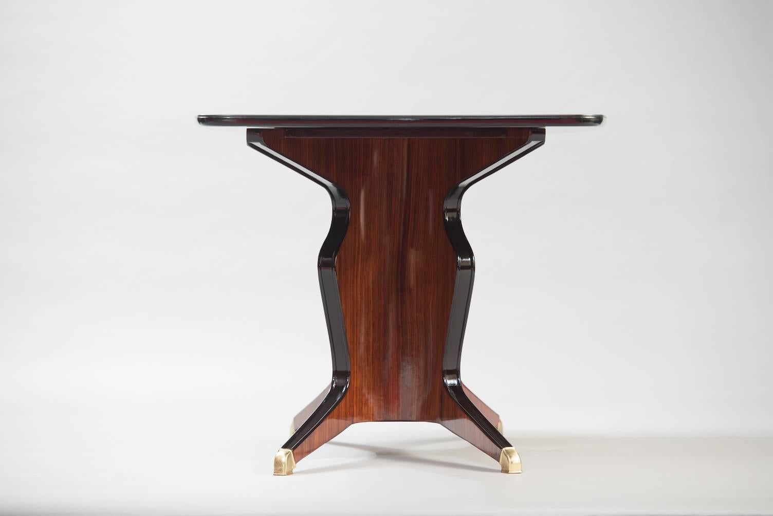 Osvaldo Borsani rosewood and brass midcentury dining table, black lacquered glass on top, manufactured by Fossati, Attilio & Arturo.