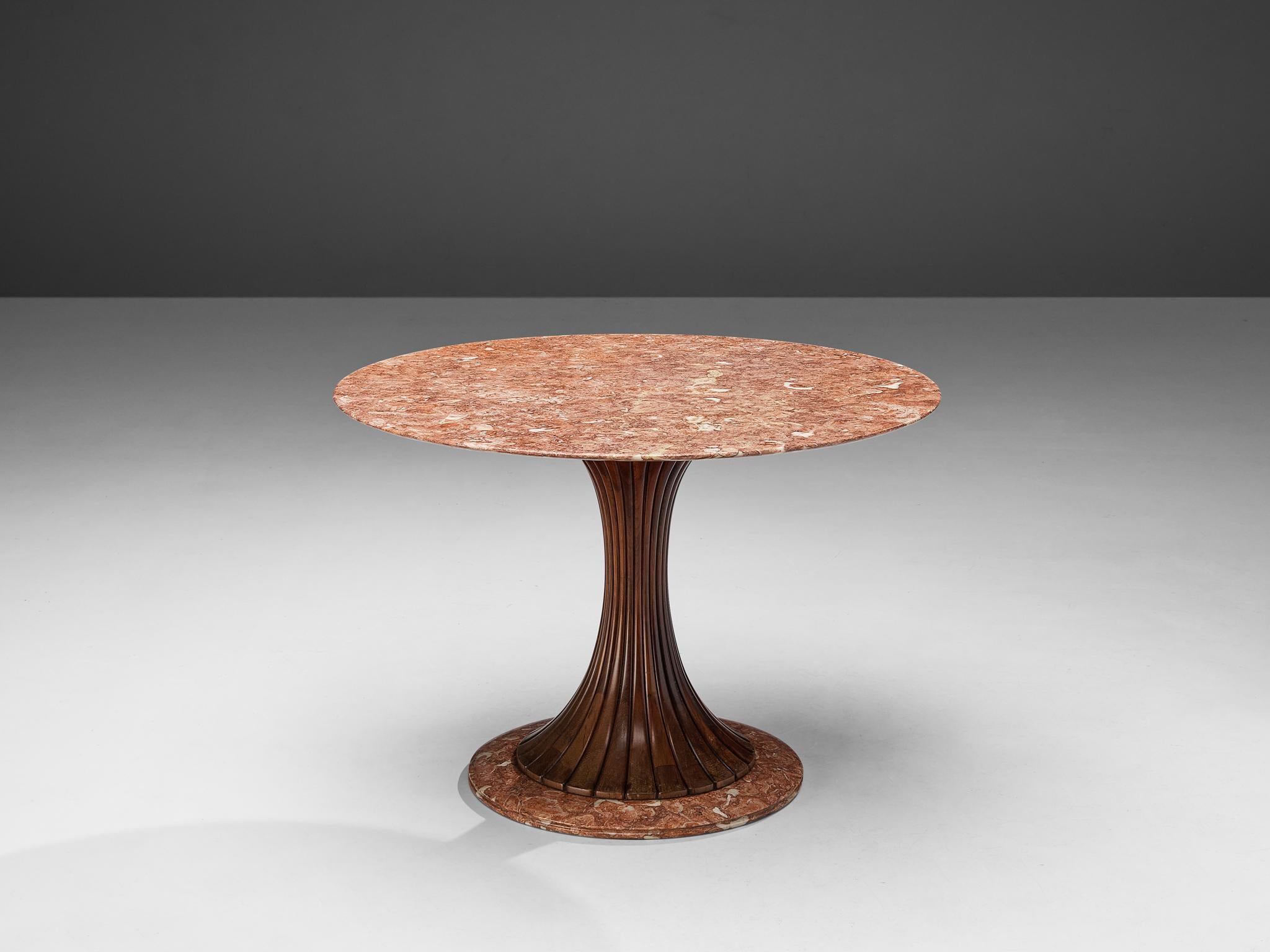 Attributed to Osvaldo Borsani, dining table, walnut, marble, Italy, 1950s

This distinctive dining or side table is attributed to Osvaldo Borsani as it bears visual similarities to Borsani’s table model ‘6542’. A round top red marble rests on an