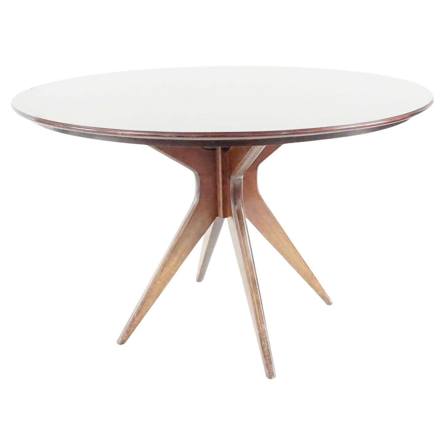Osvaldo Borsani round dining table, walnut, four feet, circa 1951