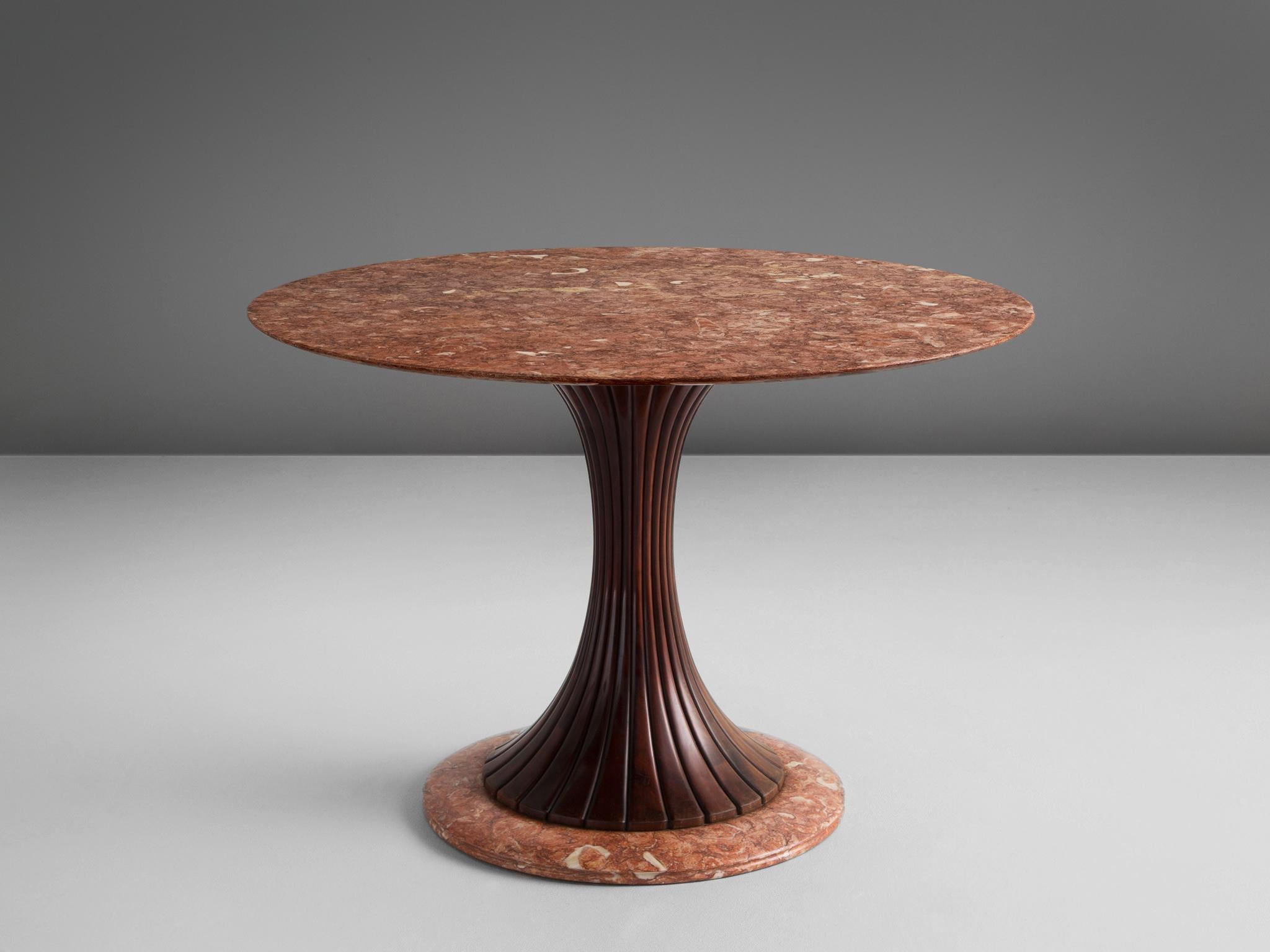 Osvaldo Borsani for Arredamento Borsani, marble wood, Italy, 1950s.

This distinctive centre table is made in the 1950s and holds a wooden decorated shaft. The main feature of this table is the red marble-top. The white and grey veins give a
