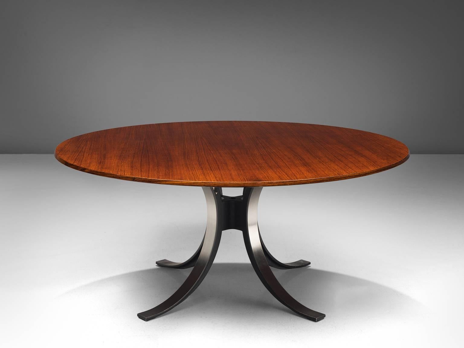 Osvaldo Borsani and Eugenio Gerli for Tecno, T-69 dining table, wood, steel, Italy, 1965.

Round dining table with wooden top and metal base. Characteristic for this table is the base. Consisting of four C-shaped legs. These semicircles together