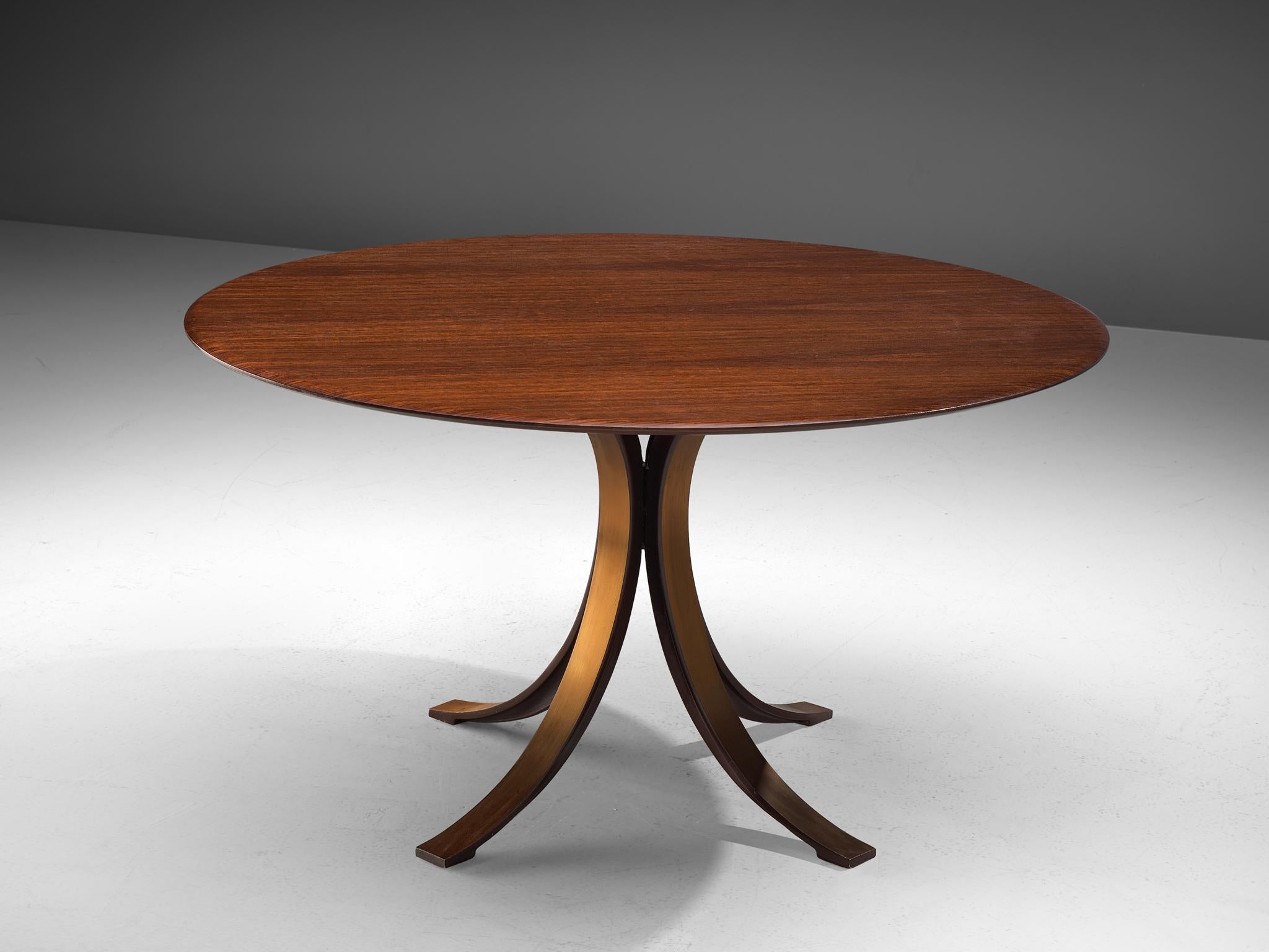 Osvaldo Borsani and Eugenio Gerli for Tecno, T-69 dining table, rosewood and metal, Italy, 1965.

Round dining table with rosewood top and copper colored, metal base. Characteristic on this table is the base. Consisting of four C-shaped legs.
