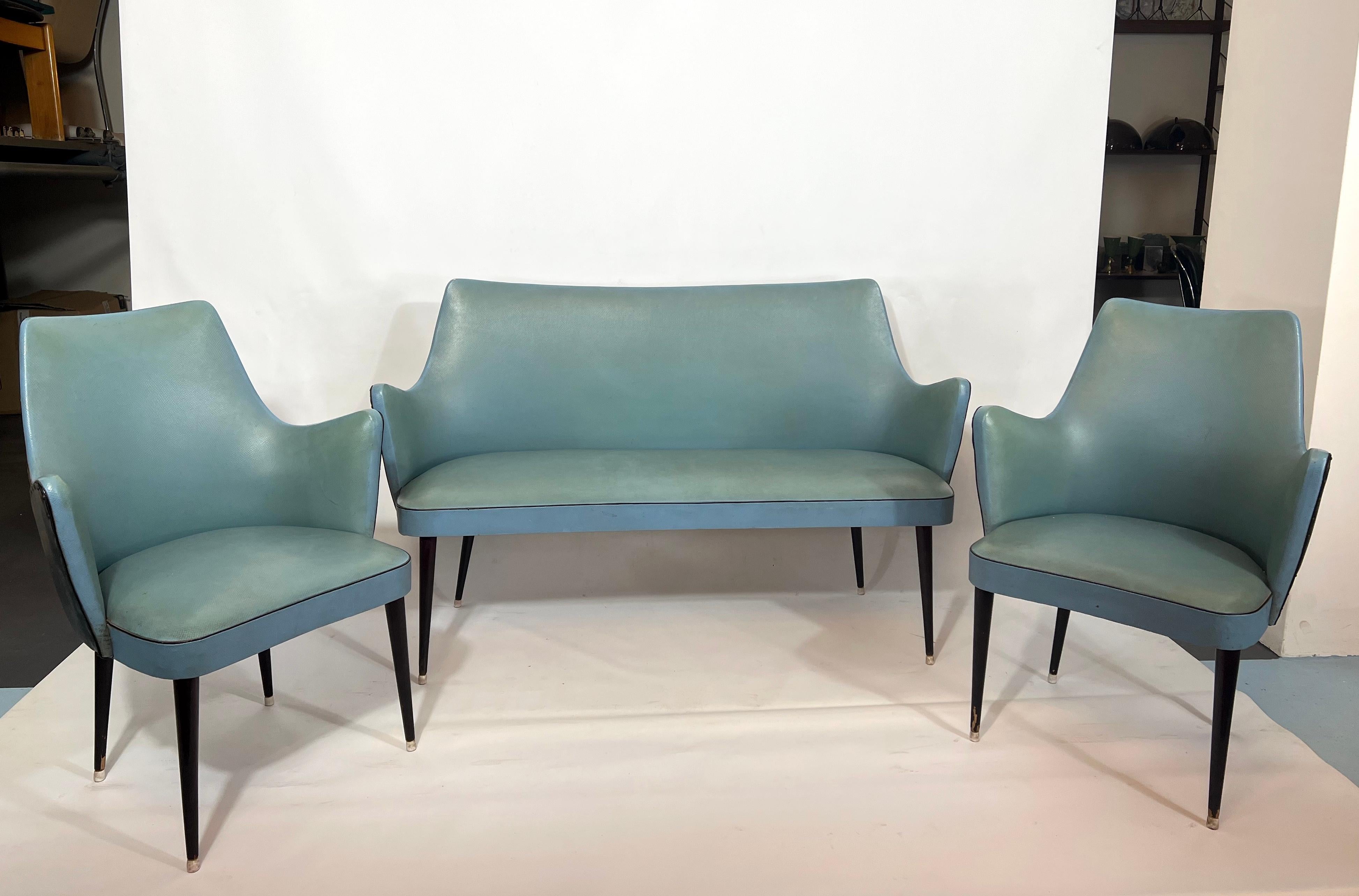 Good vintage condition for this set of one two-seater and two armchairs designed by Osvaldo Borsani and produced in Italy during the 50s. Original black and turquoise sky with trace of age and use. Dimensions: sofa H 82 W 135 D 58, armchair H 82 W