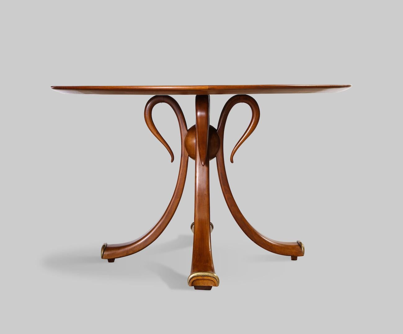Rare center/ games table, by Osvaldo Borsani. Walnut pedestal table of 4 curved wood fronds with brass trim at feet. Solid center wood ball and radius veneered circular top. Produced by Arredamenti Borsani Varedo with label to underside of top.