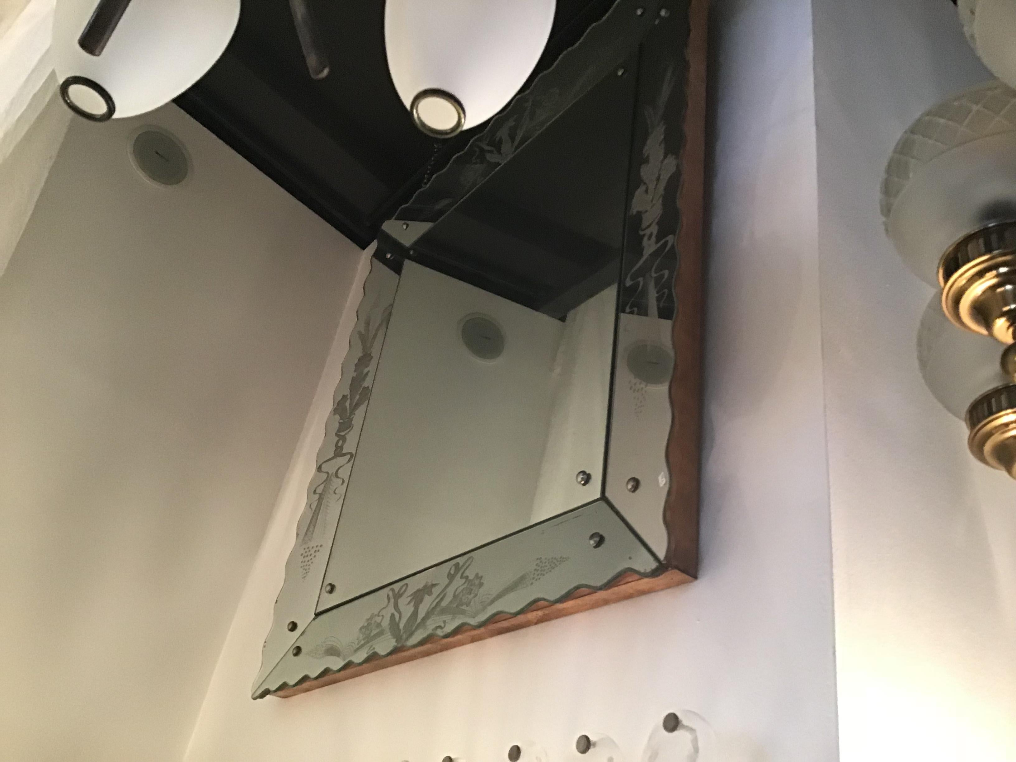 Wall mirror Osvaldo Borsani wood or mirrored glass with drawings and studs in nickel-plated metal.