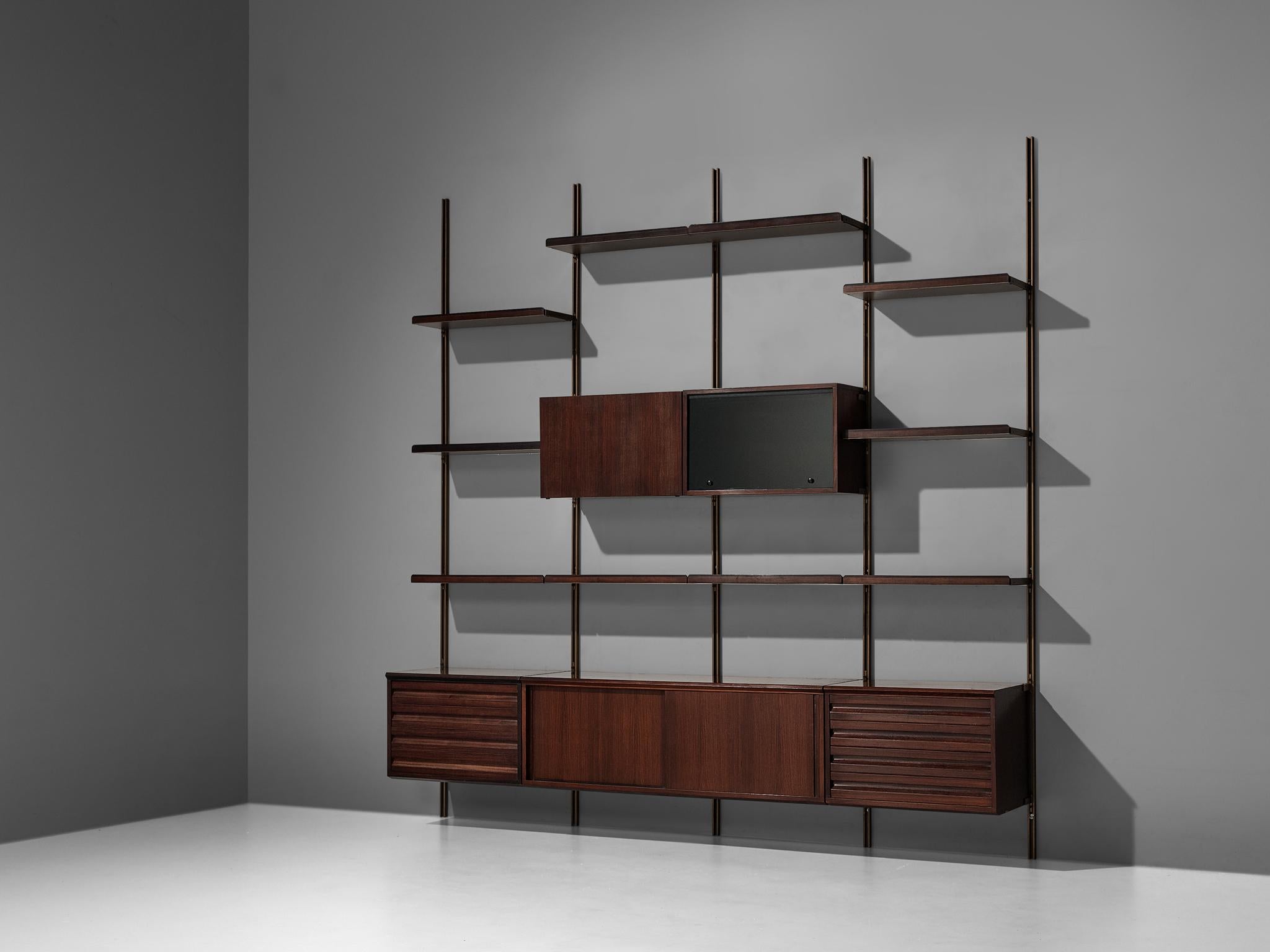 Osvaldo Borsani for Tecno, wall unit E22, in metal and rosewood, Italy, 1957

Diverse wall-mounted shelving unit by Osvaldo Borsani for Tecno. Borsani designed the E22 as a coordinated system for furnishing either the home or the office.  

The