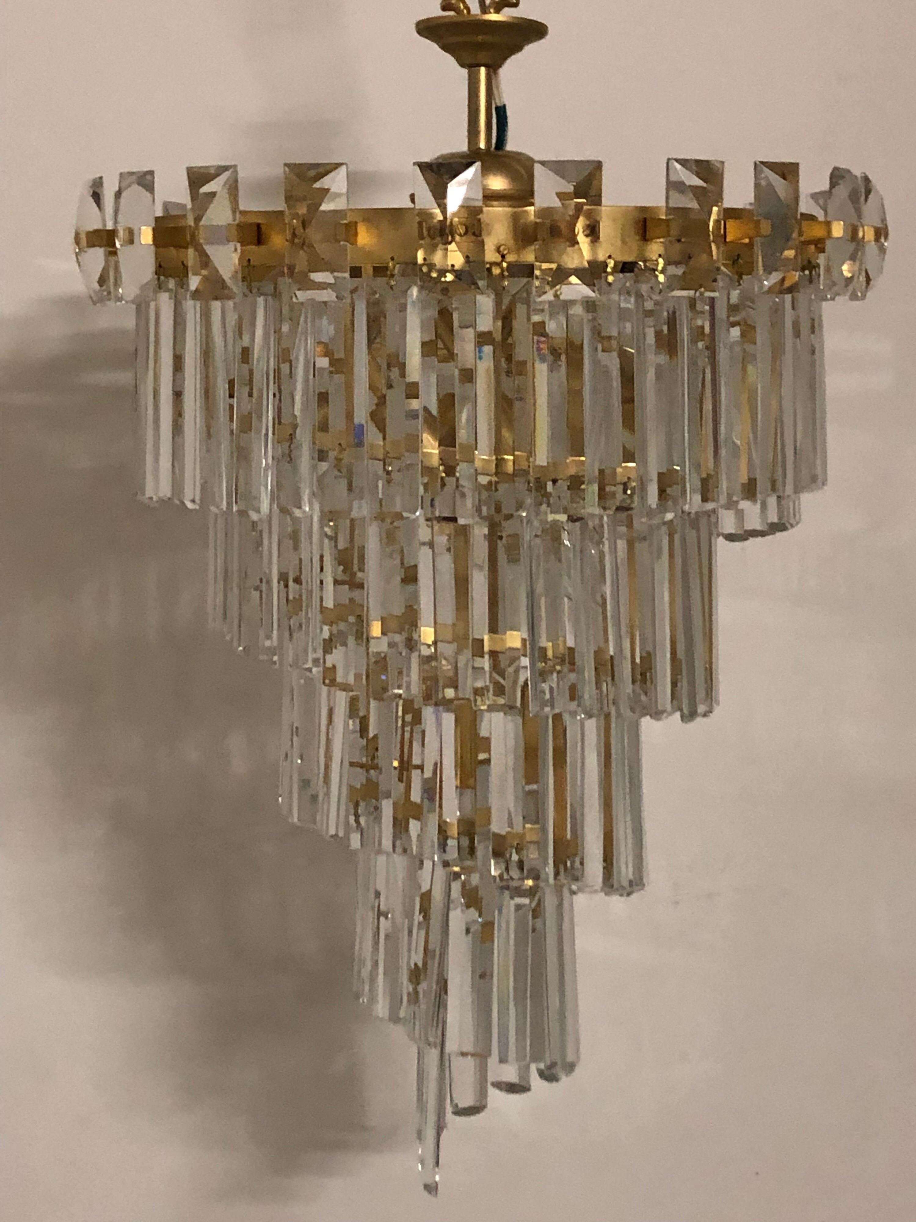 A wonderful and very rare model of a mid-century chandelier designed by Oswald Haerdtl for Lobmeyr. 
This chandelier is made of gilt brass frame with cut crystal elements. 
The chandelier takes 7 x e14 standard screw bulbs for illuminate.
 