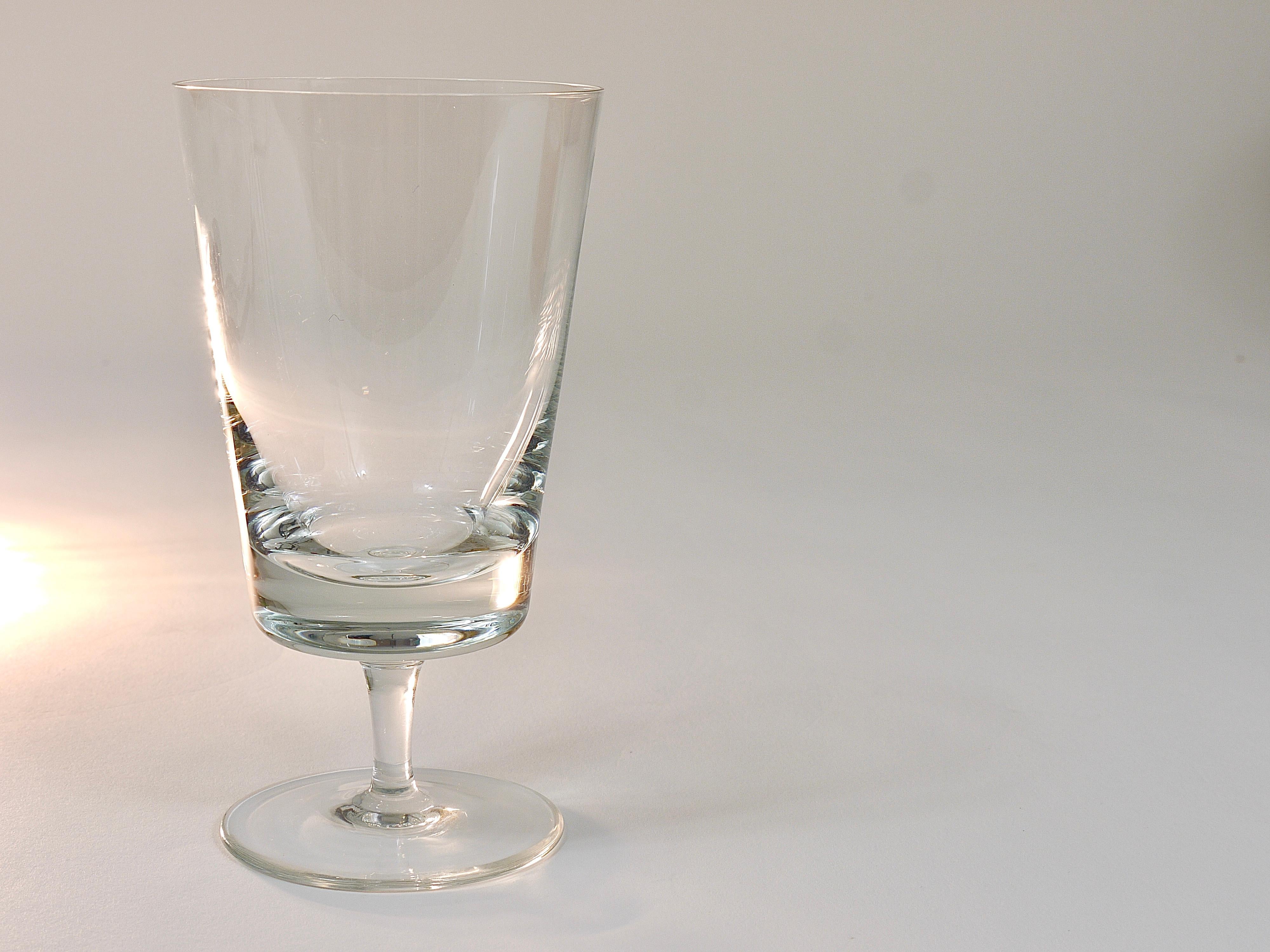 A set of six elegant and fine handmade drinking glasses for wine or water, made of clear crystal glass. Designed by Oswald Haerdtl, executed in Austria in the 1950s. In excellent condition.