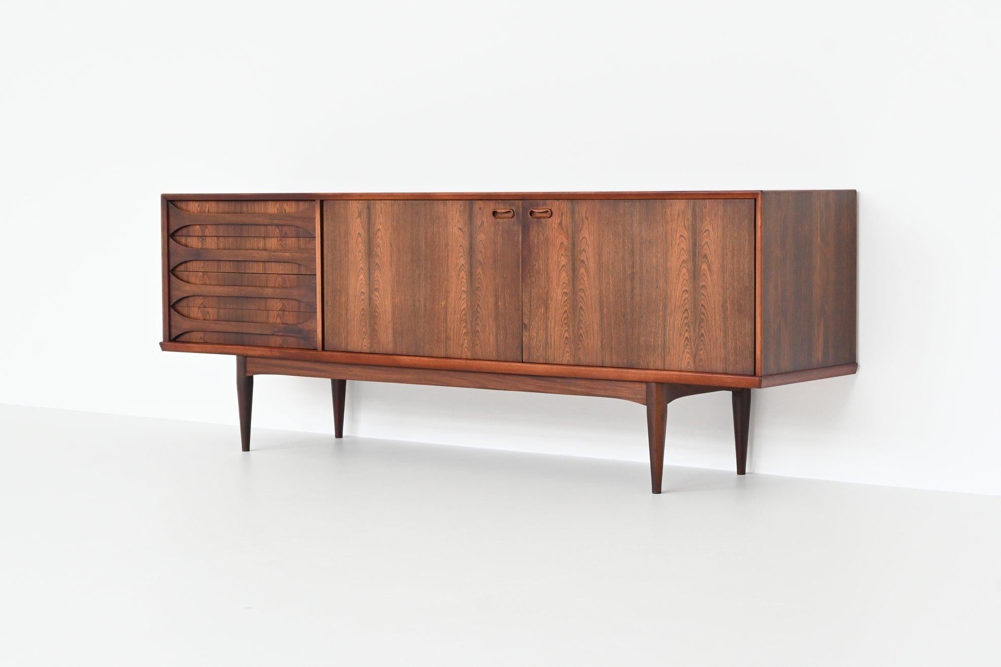 Stunning high quality sideboard model “Astrid” designed by Oswald Vermaercke and manufactured by V-Form, Belgium 1959. This sideboard is made of beautiful grained veneered rosewood with solid legs. It has two wide doors with a shelf behind and four