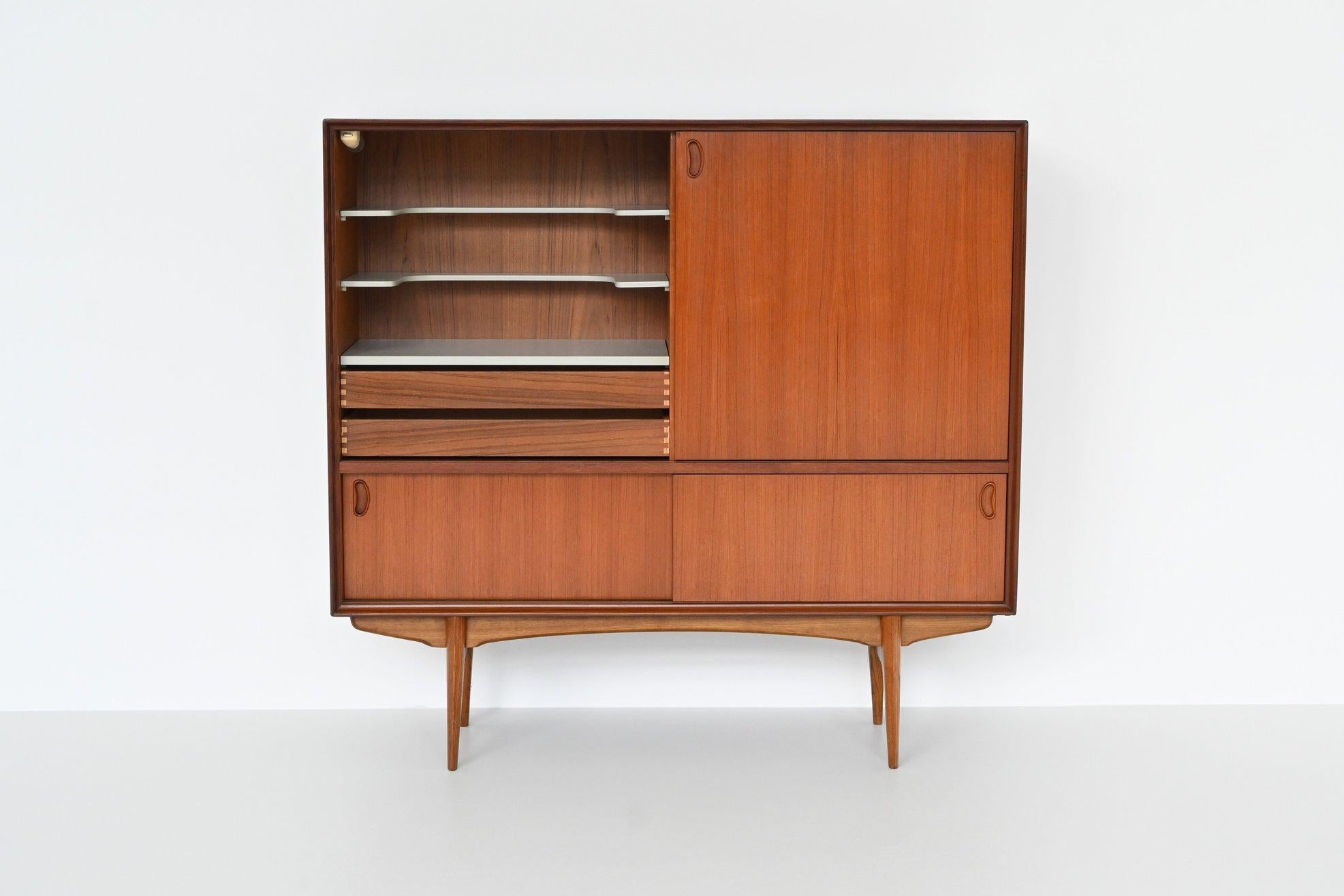 Stunning high quality bar cabinet model “Paola” designed by Oswald Vermaercke and manufactured by V-Form, Belgium 1959. This cabinet is made of beautiful grained veneered teak with solid legs. It has five sliding doors in total with two drawers