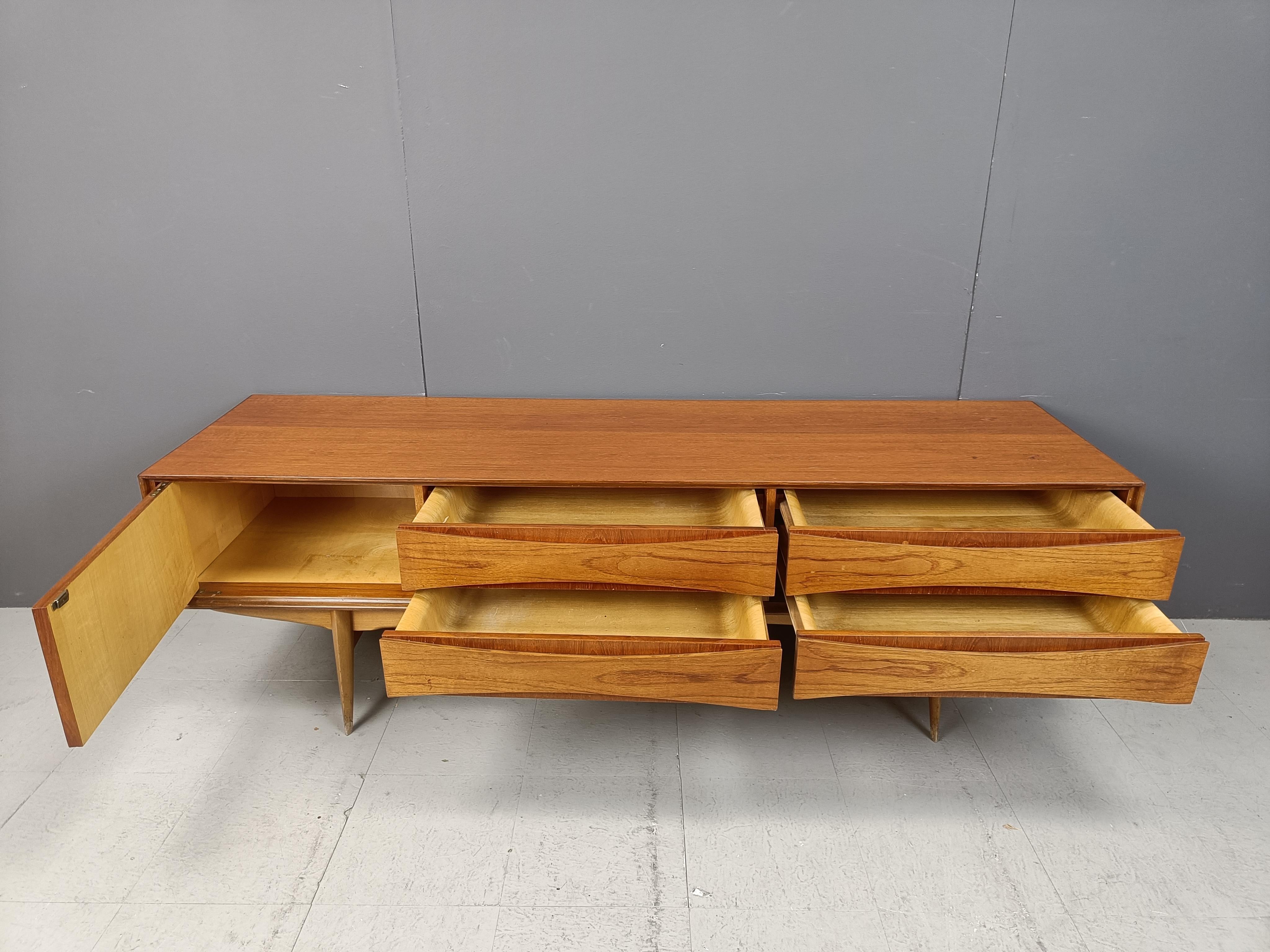 
High quality mid century modern lowboard designed by Oswal Vermaercke for V-form.

This teak wooden lowboard has one door and 4 drawers. Notice how well the drawers are made with the curvy wooden inner planels. - Very typical for Vermaercke's