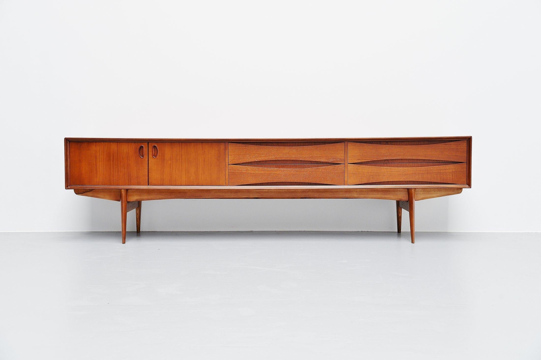 Very nice and quality low sideboard designed by Oswald Vermaercke and manufactured by V-Form, Belgium 1959. This amazing credenza has a very nice and warm teak color and is fully refinished into perfect condition. The designs by Oswald Vermaercke