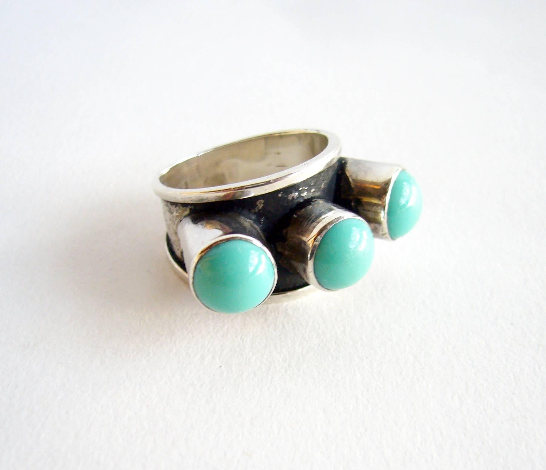 Sterling silver and turquoise ring created by master sculptor, painter and jeweler, Oswaldo Guayasamin of Ecuador.  Ring is a finger size 7 and is signed GuayasaminIn, 900.  In very good vintage condition.