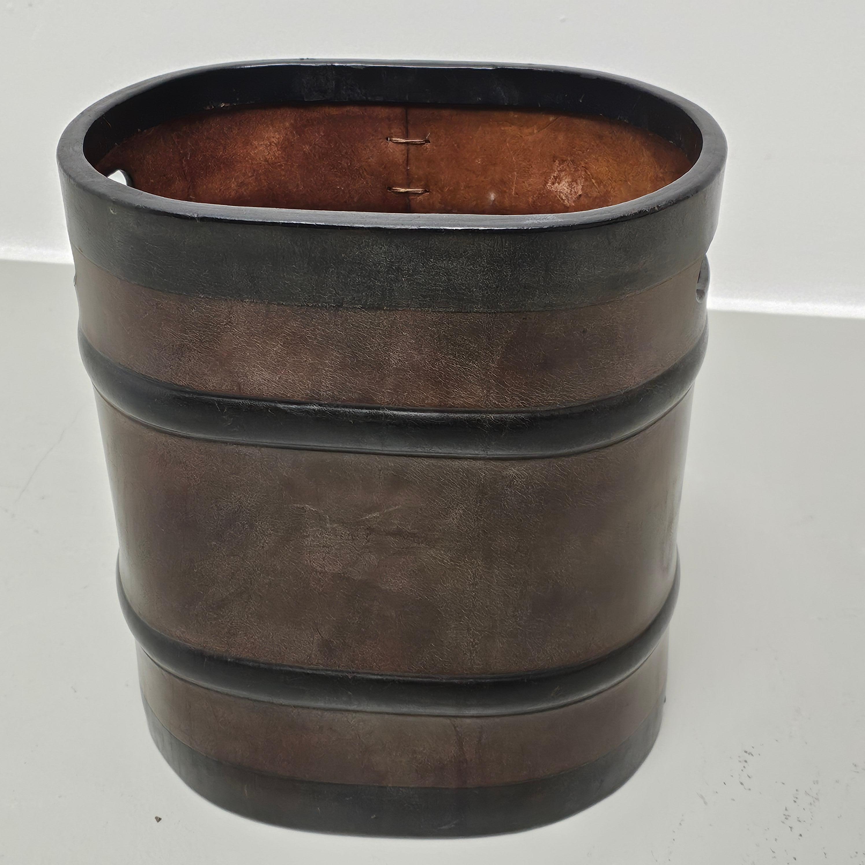 Nice little paper waste bin. Made out of thick brown leather with black colored pressed details and large stitching. Possibly South American / Brasilian manufactured in the 60's or 70's. Labelled  with a Brasilian address in Rio de Janeiro and the