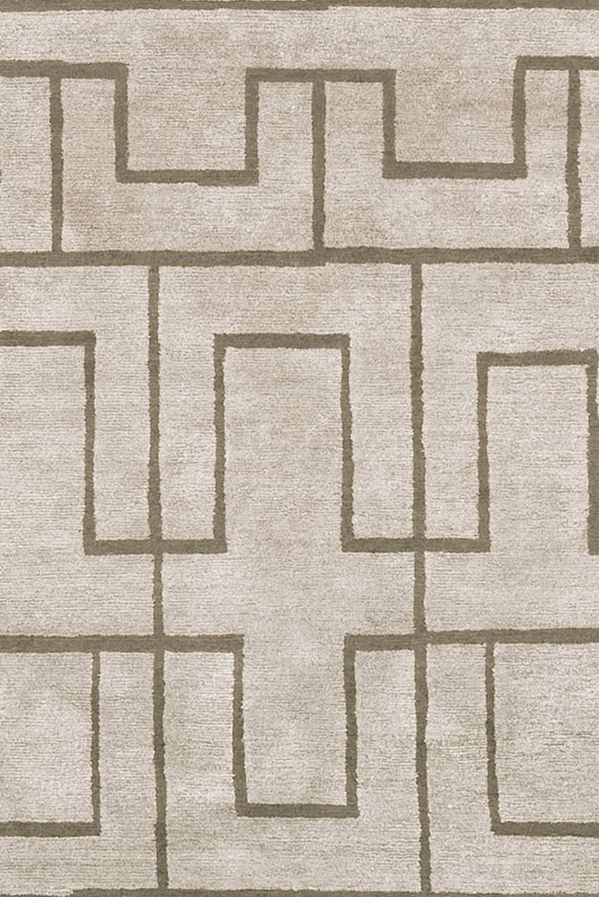 Otane rug is made in blended wool and silk (70-30%). 
Low pile (5-6 mm). 
Quality: 100 knots by square inch. 
Base light warm grey, pattern olive green brown.
Hand-knotted in Nepal.