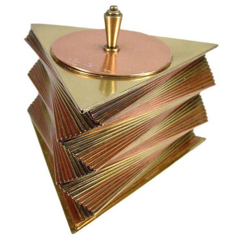 This rare 1935 all-original decorative box was designed and produced by John Otar in California. The box features individual triangular brass and copper plates stacked to create a spectacular, twisting spiral form. It is signed on the bottom, inside