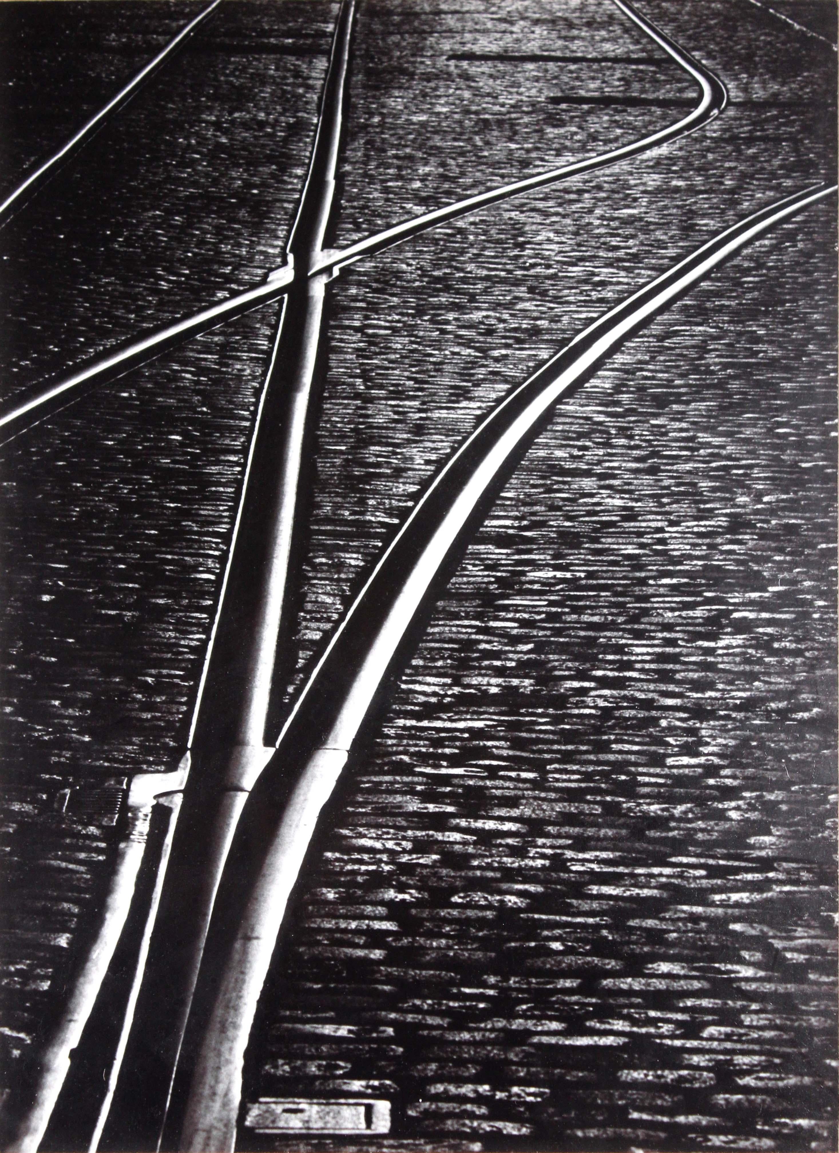 An ethereal silver gelatin photograph titled “Railroad Tracks” by Otis Sparrow. Dated 1978. An elegant depiction of railroad tracks via an aerial view. Provenance: This photograph was part of a collection of a seasoned art expert who amassed an