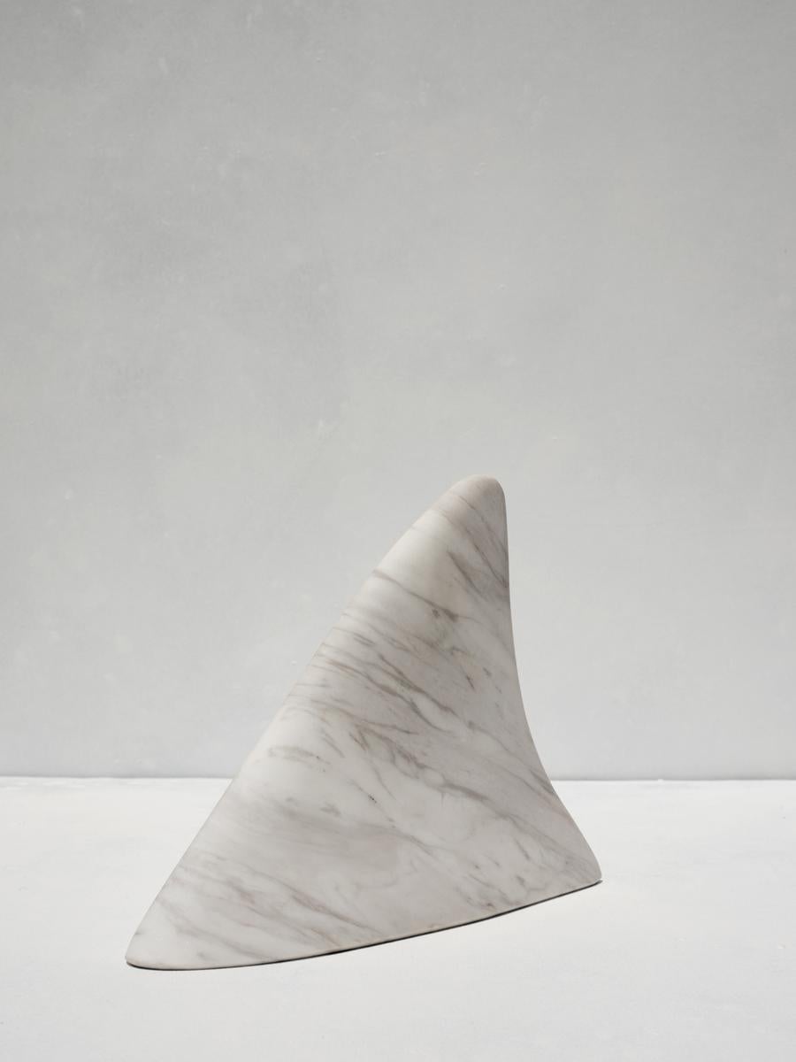 Otos bookend by Faye Tsakalides. 
Dimensions: 21 W x 28 L x 6 H cm
Materials: White Volakas marble. 
Technique: Crafted from a single piece of marble. Hand-crafted, Polished. Mat finished. 

Faye Tsakalides is a Greek architect and designer