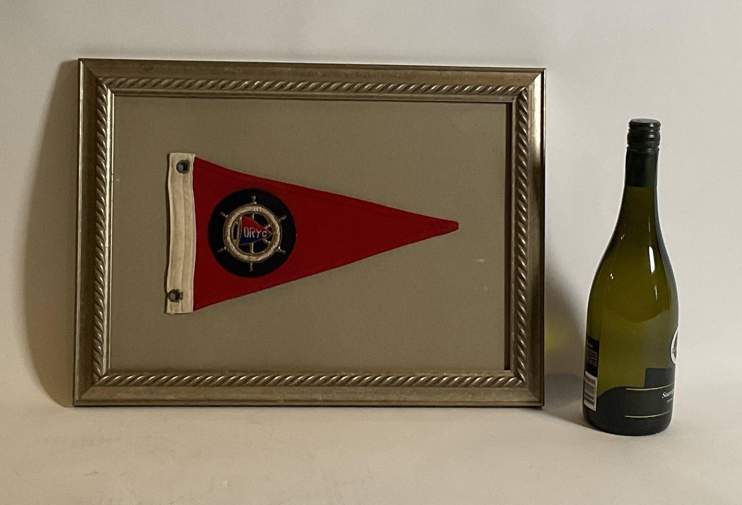 Framed nautical flag with an embroidered flag from the Ottawa River Yacht Club, The burgee flag is fitted inside a ships wheel. Nicely framed 

Weight: 3 lbs.
Overall Dimensions: 13