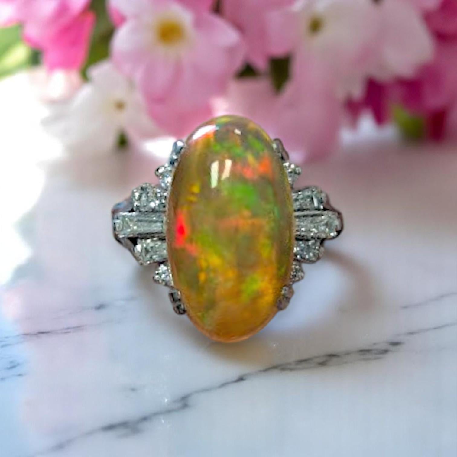 This stunning platinum ring features a mesmerizing 4.63-carat fire opal accented by 0.52 carats of natural diamonds, creating a bold and elegant statement piece. Perfect for engagements, anniversaries, or fine jewelry collectors, this ring is a true