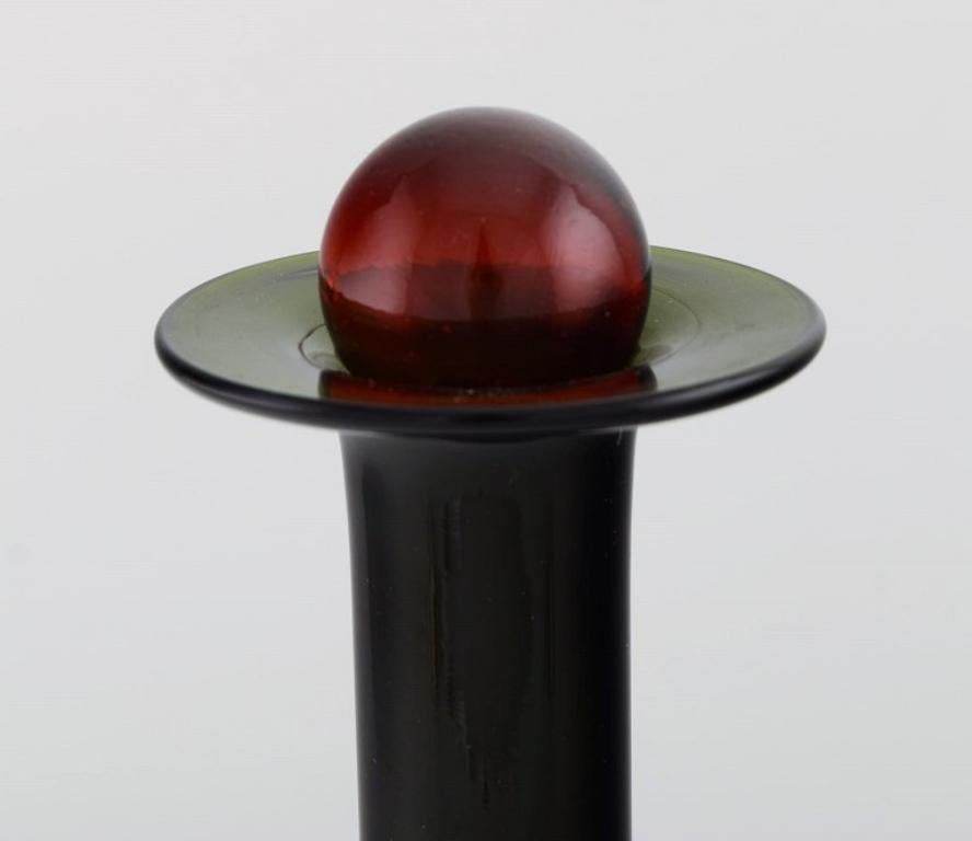 Otto Brauer for Holmegaard. Bottle in green art glass with red ball, 1960s In Excellent Condition In Copenhagen, DK