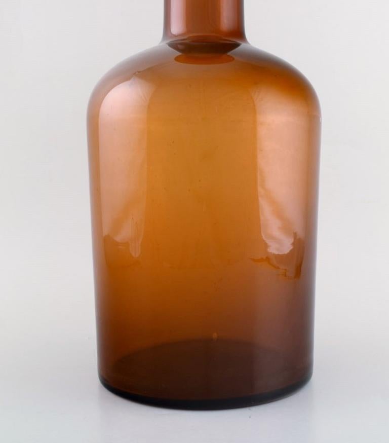 Scandinavian Modern Otto Brauer for Holmegaard. Bottle in Light Brown Art Glass with orange Ball For Sale