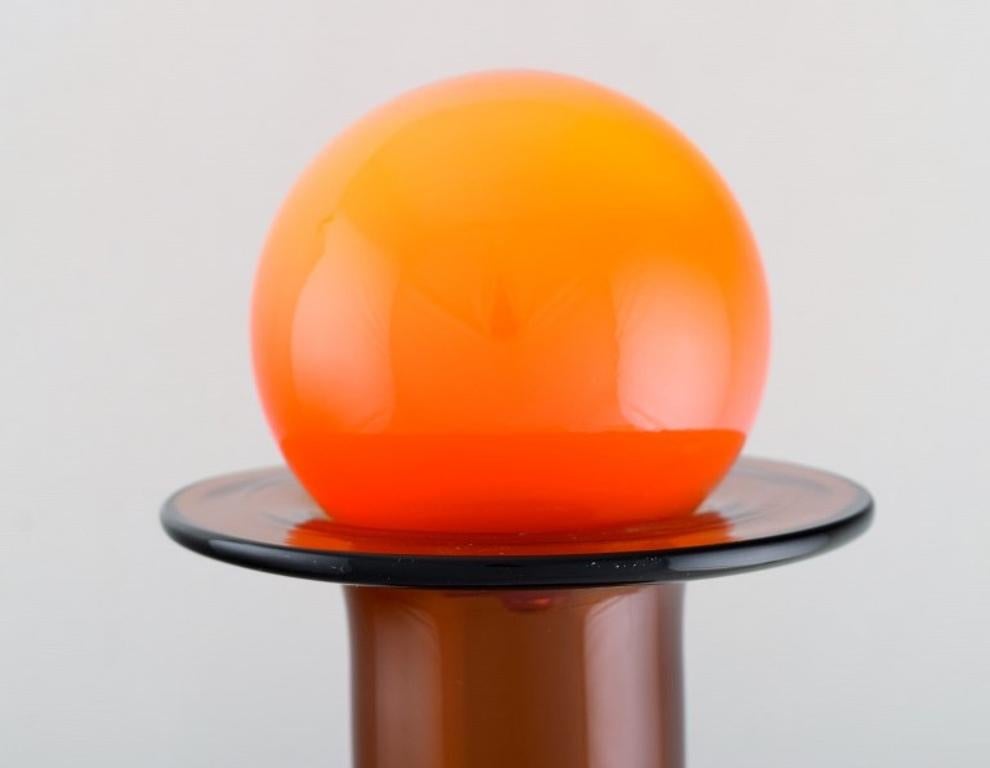 Danish Otto Brauer for Holmegaard. Bottle in Light Brown Art Glass with orange Ball For Sale