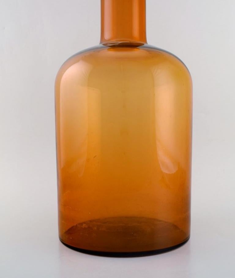 Scandinavian Modern Otto Brauer for Holmegaard. Colossal bottle in brown art glass with red ball For Sale