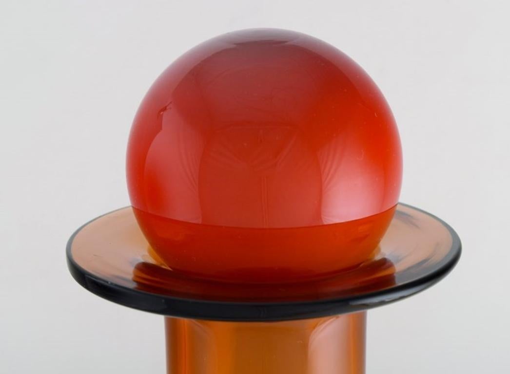 Danish Otto Brauer for Holmegaard. Colossal bottle in brown art glass with red ball For Sale