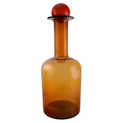 Otto Brauer for Holmegaard. Colossal bottle in brown art glass with red ball