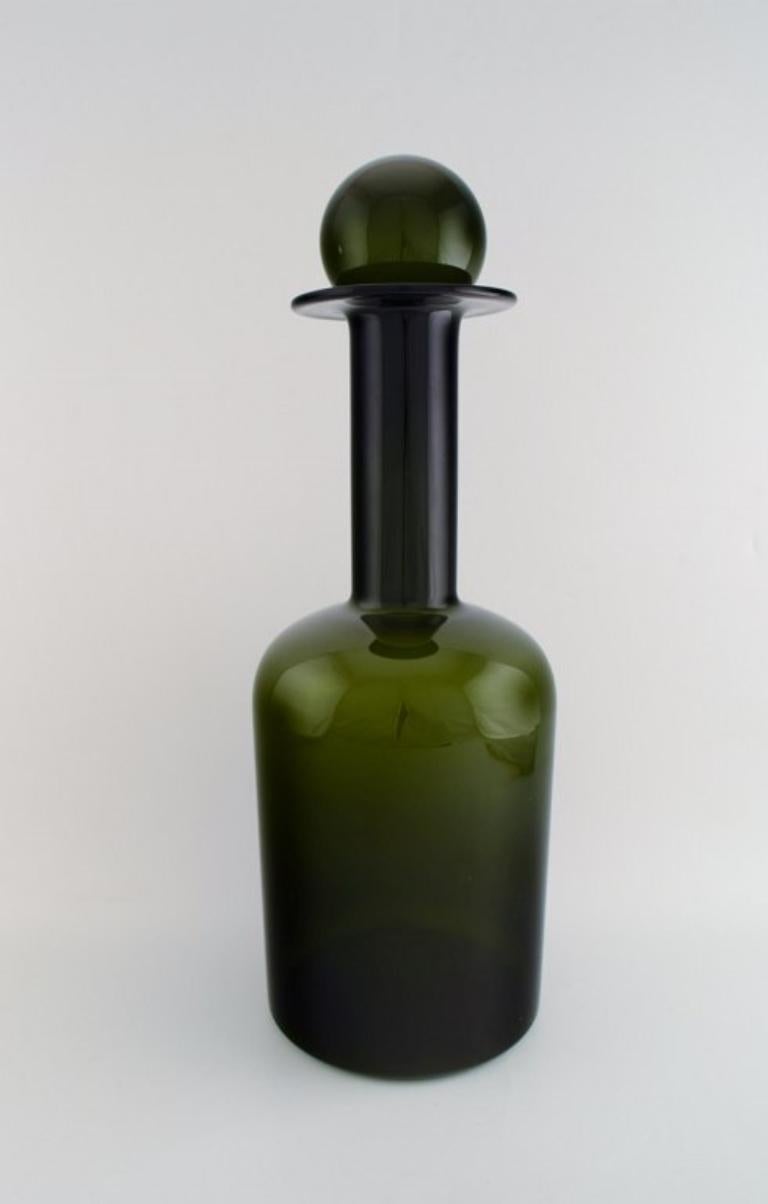 Otto Brauer for Holmegaard. 
Colossal vase / bottle in green art glass with green ball. 1960's.
Measures: 51 cm. x 19 cm.
In perfect condition.