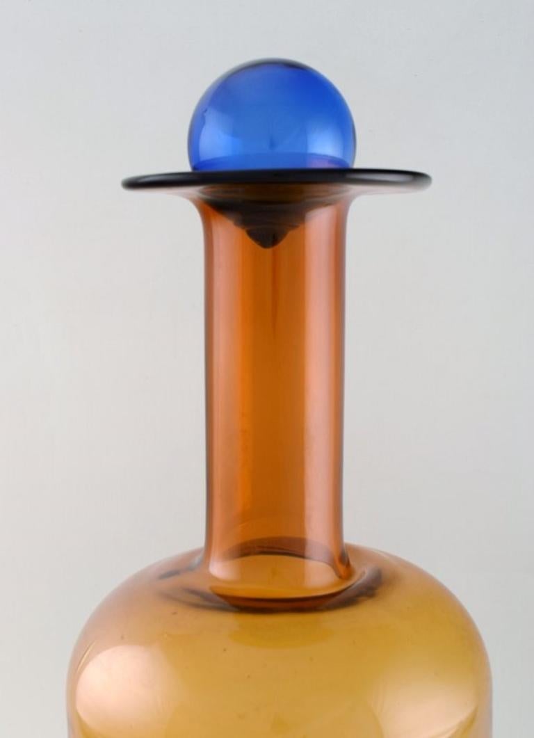 Otto Brauer for Holmegaard. 
Colossal vase or bottle in brown art glass with blue ball.
1960s.
Measures: 54 x 20 cm (incl. Ball).
In perfect condition.

  