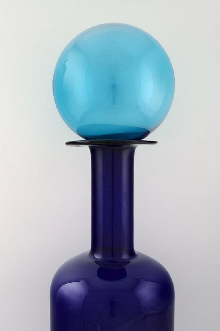 Otto Brauer for Holmegaard. Giant vase / bottle in blue art glass with blue ball. 1960's.
Measures: 68.5 x 21 cm (incl. Ball).
In perfect condition.