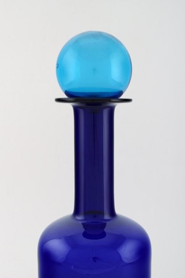 Otto Brauer for Holmegaard. 
Large vase / bottle in blue art glass with blue ball. 1960's.
Measures: 37.5 x 12 cm (incl. Ball).
In perfect condition.