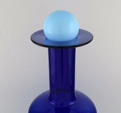 Otto Brauer for Holmegaard. Large bottle in blue art glass with light blue ball.