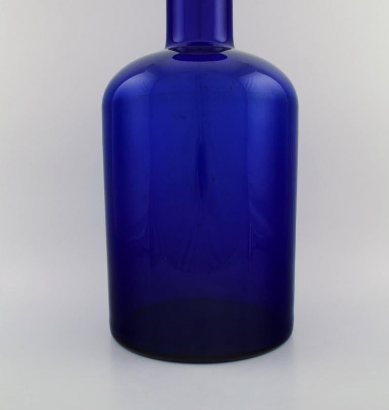 Danish Otto Brauer for Holmegaard. Large bottle in blue art glass with light blue ball. For Sale