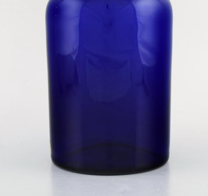 Scandinavian Modern Otto Brauer for Holmegaard. Large bottle in blue art glass with purple ball For Sale