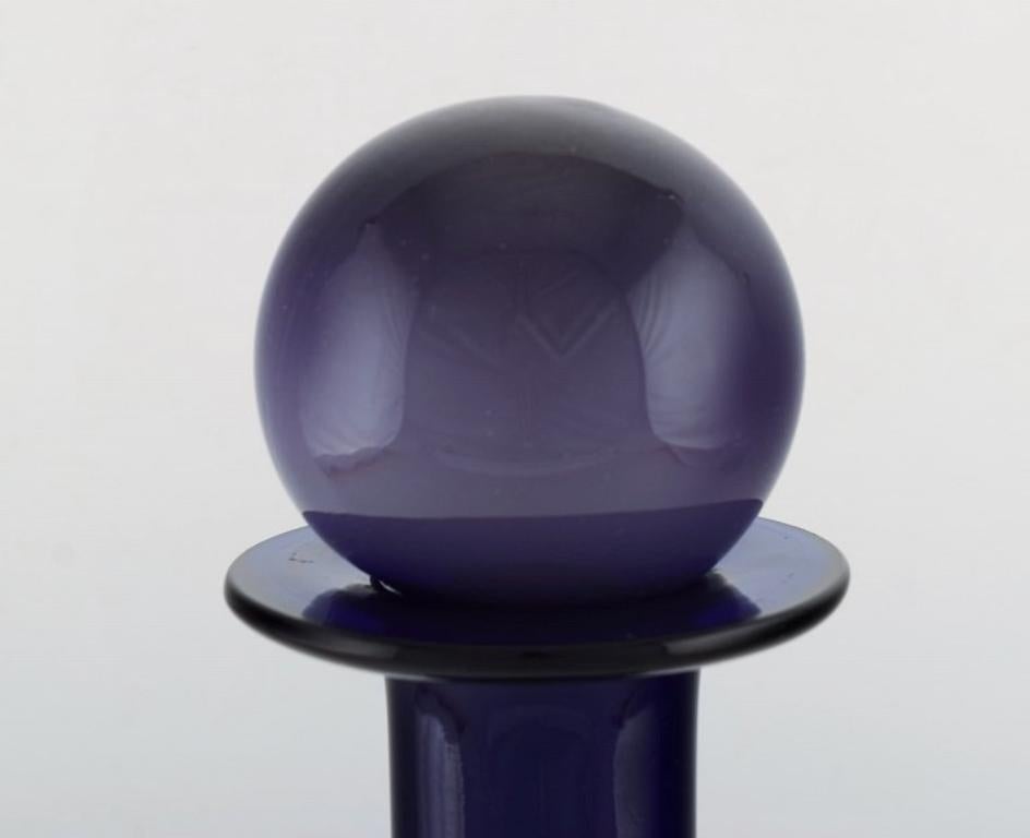 Danish Otto Brauer for Holmegaard. Large bottle in blue art glass with purple ball For Sale