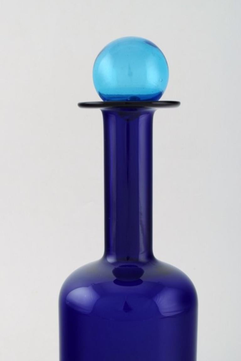 Otto Brauer for Holmegaard. 
Large vase / bottle in blue art glass with blue ball. 1960's.
Measures: 30 x 9.5 cm (incl. Ball).
In perfect condition.

 