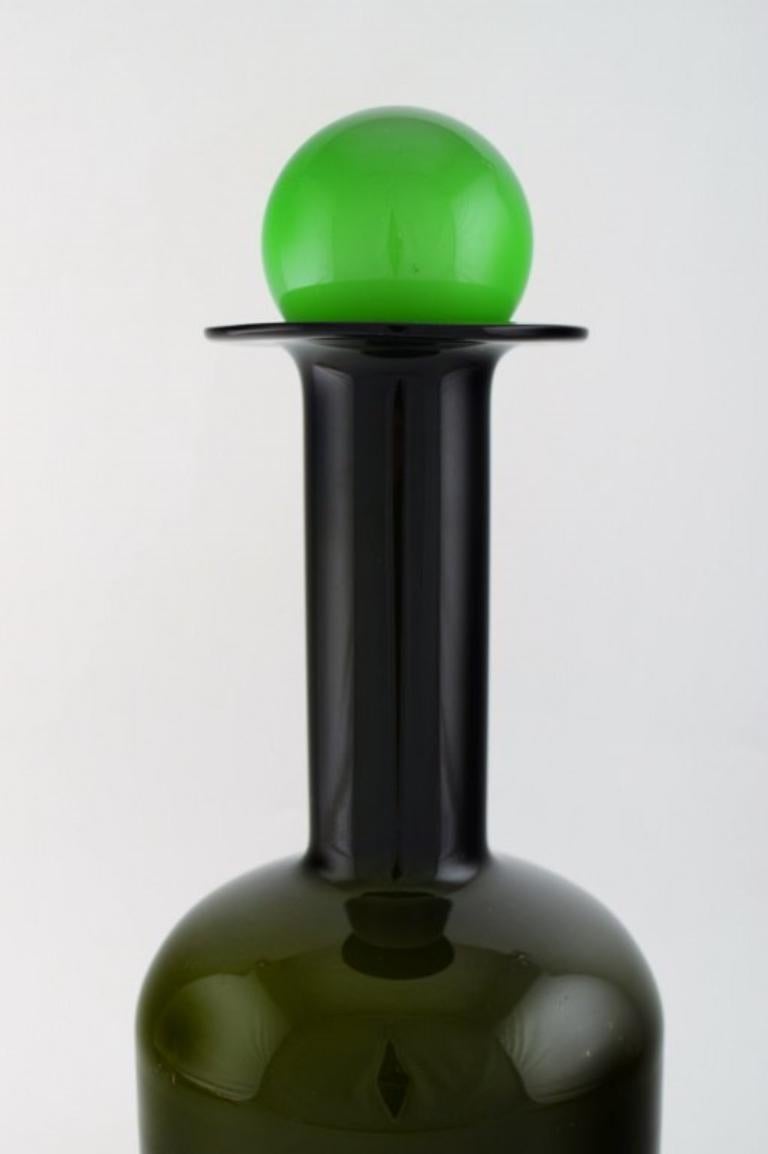 Otto Brauer for Holmegaard. 
Large vase / bottle in green art glass with green ball, 1960s.
Measures: 43 x 15 cm (incl. Ball).
In perfect condition.

   
  