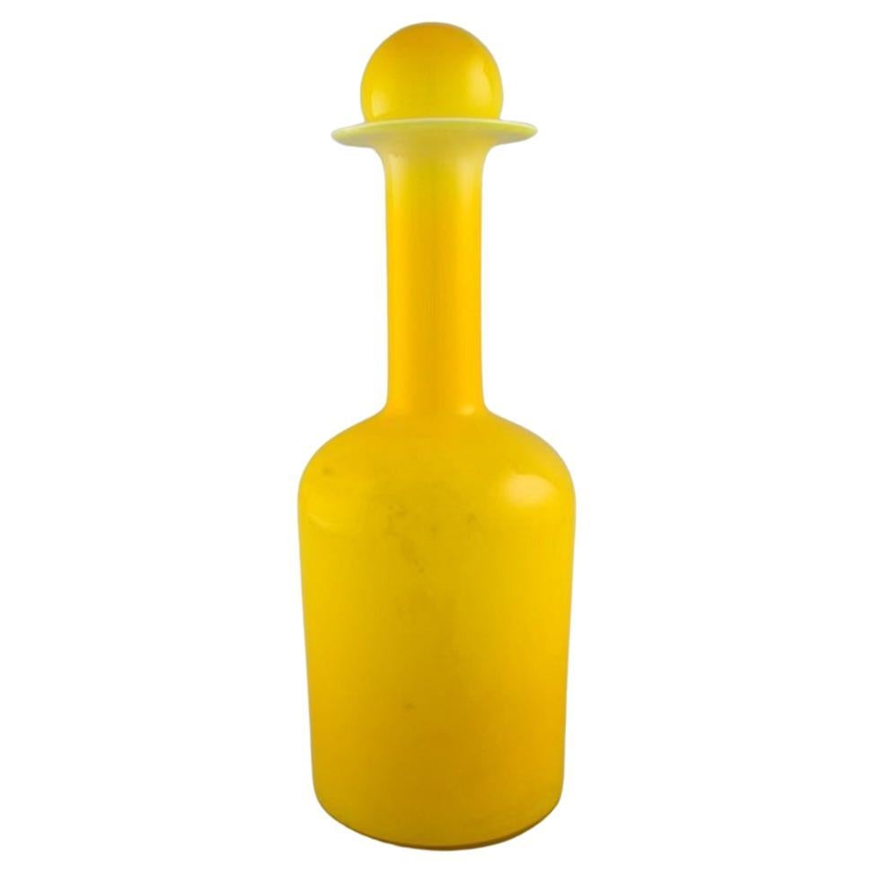 Otto Brauer for Holmegaard. Large bottle in yellow art glass with yellow ball For Sale
