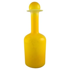 Otto Brauer for Holmegaard. Large bottle in yellow art glass with yellow ball