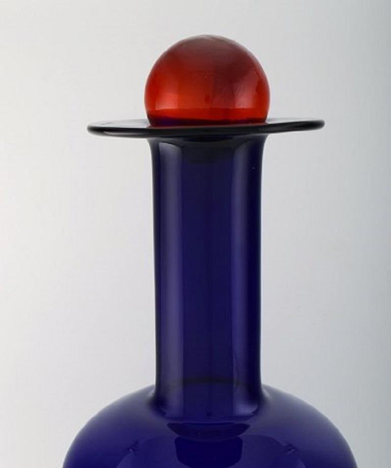 Otto Brauer for Holmegaard. Large vase/bottle in blue art glass with red ball, 1960's.
Measures: 55 x 21 cm (incl. Ball).
In perfect condition.
