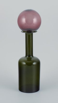 Otto Brauer for Holmegaard. Vase/bottle in green art glass with purple ball.