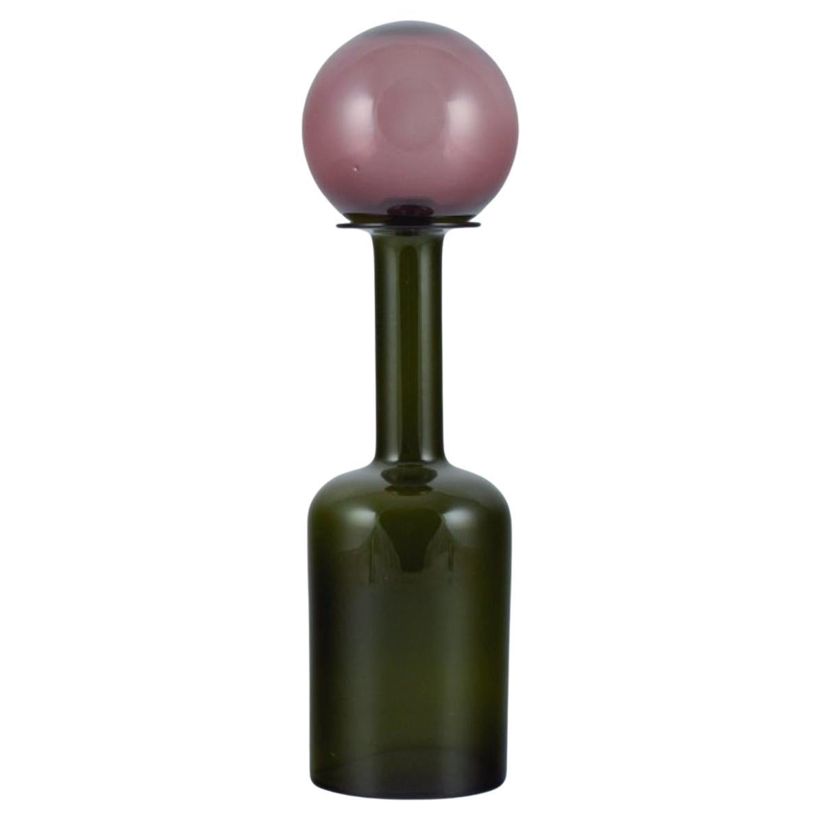 Otto Brauer for Holmegaard. Vase/bottle in green art glass with purple ball. For Sale