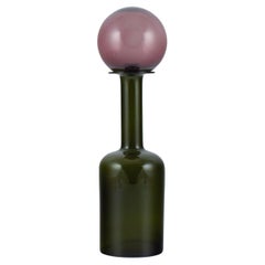 Otto Brauer for Holmegaard. Vase/bottle in green art glass with purple ball.