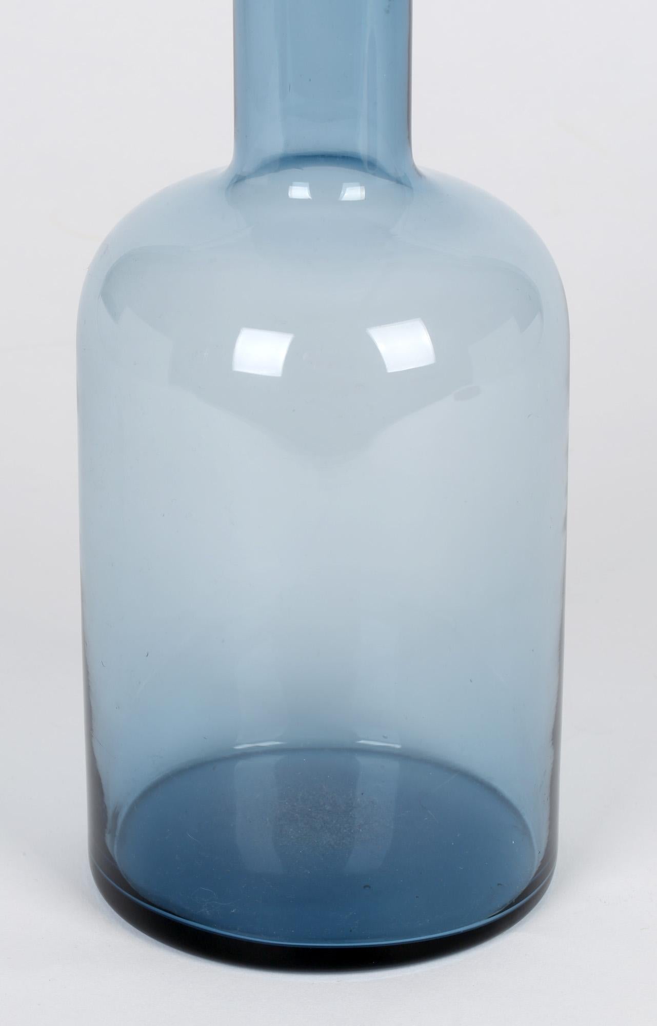 A stylish Danish art glass Gulvase designed by Otto Brauer for Kastrup Holmegaard in the 1960's. The vase made in light blue tinted glass has a cylindrical shaped body tall slender neck and a flat folded back top. The vase one of the most iconic and